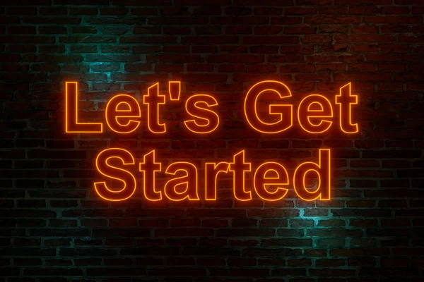 Let\'s get started, neon sign. Brick wall at night with the text \