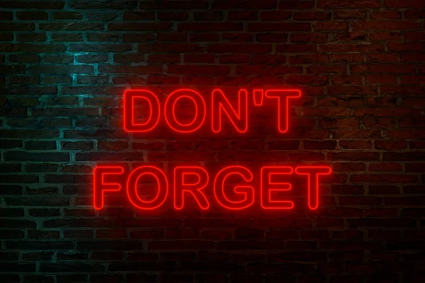 Don\'t forget, neon sign. Brick wall at night with the text \