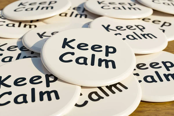 Keep Calm badge. White badges laying on the table with the message \