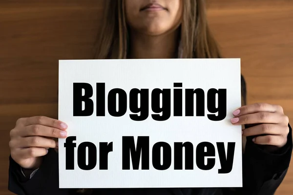 Blogging for money. Woman holds a white page with text \