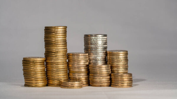 Piled up euro coins. Stacked one euro, two euro and fifty cent coins. European currency. 