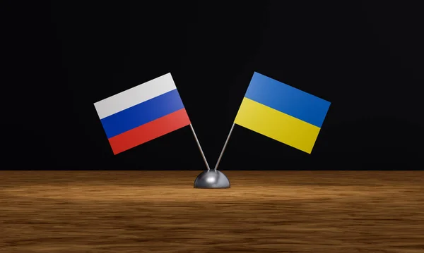 Negotiations between Russia and Ukraine. Flag of Russia and Ukraine on a table as symbol for negotiations between both countries. Political, trail and conference concept.