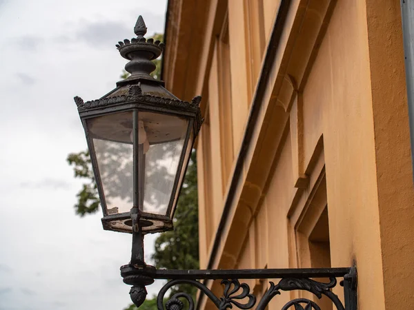 Ancient electric street lamp on house. Electric light to brighten the area in front of the entrance.
