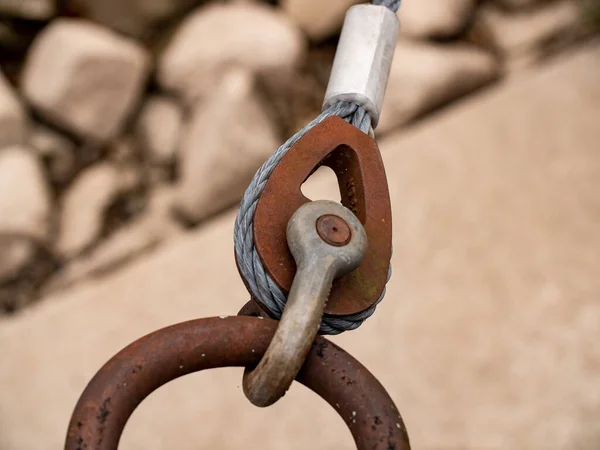 Rusty wire rope clip. The metal ring holds the wire rope clip with the rope  to fix a pontoon on a river.