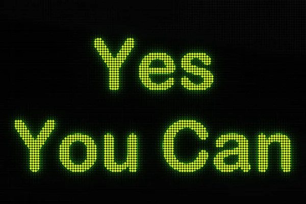 Yes You Can, the text is displayed on a LED screen.  The text 