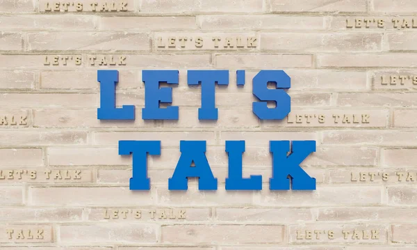 Let\'s talk. 3D letters in blue on a bright brick wall. Framed by some Let\'s Talk in beige color in small letters.