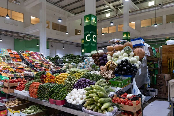 stock image United Arab Emirates, Dubai, waterfront market, April 2023: Retailer offer fruits and vegetable on the market. Melons, tomatoes, onions, paprika, ginger, oranges, pumpkin, bananas, beans, pepper, citrus and so on .