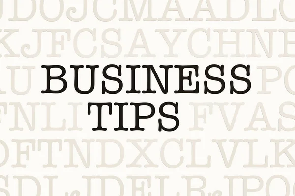 Business Tips. Page with letters in typewriter font. Part of the text in dark color. Business tip, advice, guideline, rule, manual, strategy, hint, management, instruction and procedure.