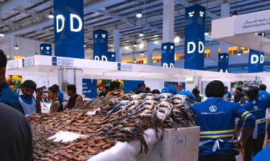 Dubai, Deira, Birleşik Arap Emirlikleri - Nisan 2023: Rıhtım kıyısı balık pazarı. Perakendeciler pazardaki tezgahlarında taze balık ve kabuklular sunuyorlar. Buzda farklı türde balıklar. Morina, Hamour balığı, deniz çerezi, Shari balığı, kral balığı, karides ve karides..