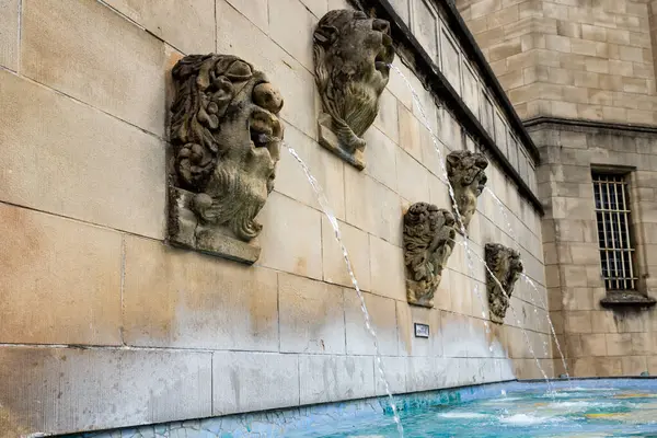 stock image Old fountain with bizarre faces next to the crypt of the Cathdrale Notre Dame in Luxembourg. 