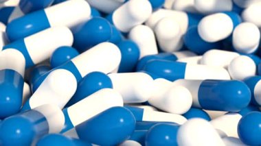 Yakın plan mavi ve beyaz kapsüller, ilaçlar. Sağlık ve ilaç. Antibiyotik endüstriyel üretimi.