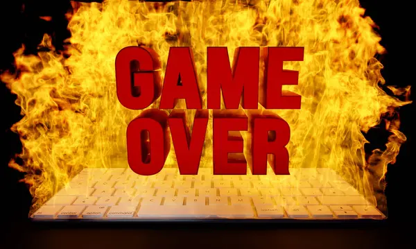 stock image Game Over, burning computer keyboard. Glowing fire, red capital letters. 