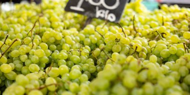 Rotterdam 'daki haftalık pazarda yeşil üzüm ve diğer meyveler sunulmaktadır. Sağlıklı yiyecek, olgun, hazır yemek, market tezgahı, tüccar, fiyat etiketi, yiyecek..