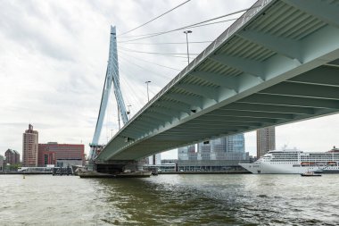 View of the Erasmus Bridge from below. Heavy steel construction. Travel destination in Rotterdam, Netherlands. clipart