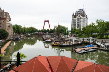 Rotterdam, Netherlands - July 9, 2004: Some boats laying at the dock in the Oudehaven of Rotterdam. The Witte Huis building and the Willems bridge in the background. clipart