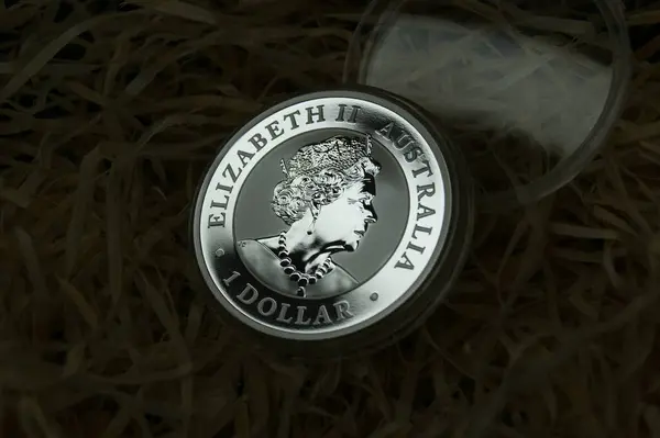 Silver Australian dollar in a capsule with the image of the Queen. A pure silver investment coin.