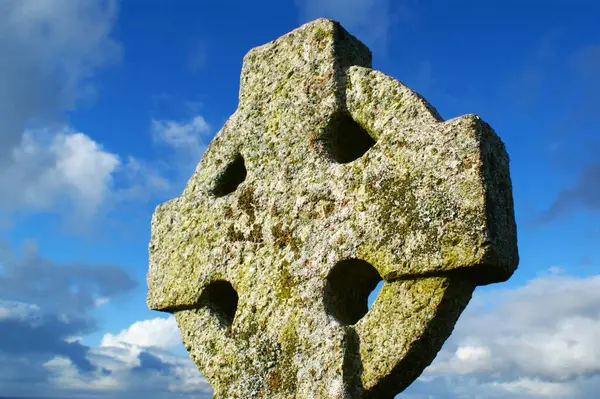 Stone cross. Old Celtic cross on sky background.