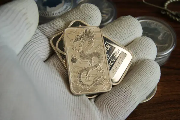 stock image 1 oz pure silver bars in assayer's hand. Investments in precious metals.