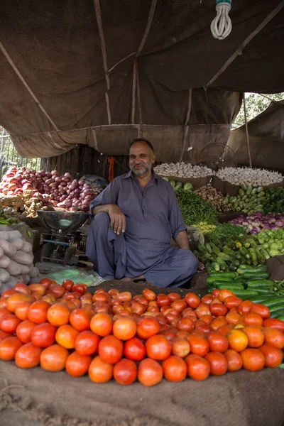 stock image view of a male seller on traditional market in the asian city