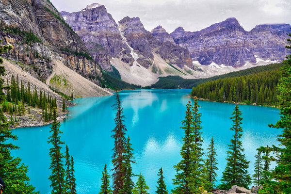 The crystal clear turquoise blue waters of Moraine Lake, the prized jewel of the Banff National Park, Alberta, Canada
