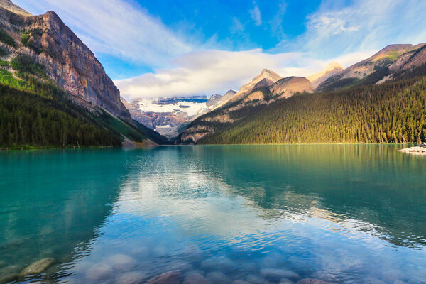 The Iconic  world famous  picture perfect Lake Louise is framed in the early morning sun near Banff in the Canada rockies