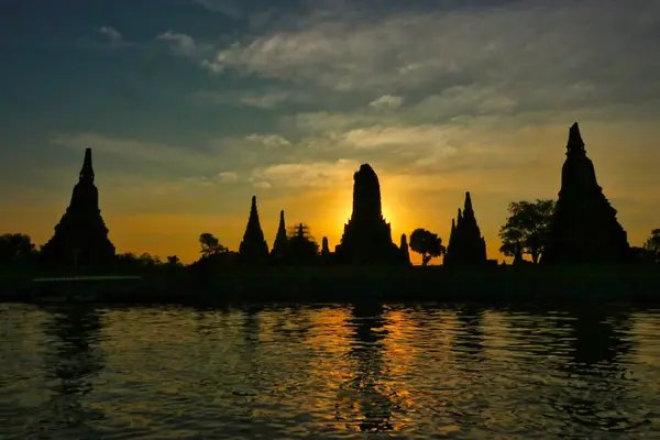 Ayutthaya 'nın antik Budist tapınaklarının siluetleri Ayutthaya, Tayland' da batan güneşe karşı