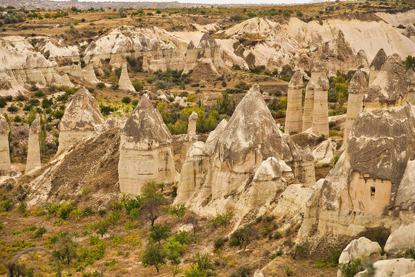 The unique rock caves, fairy chimneys and rock pillars in the Red valley seen from the Panoramic point near Goreme in the Cappadocia Region, Central Anatolia,Turkey.
