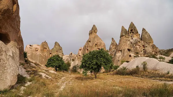 Uchisar Castle entrance path with view of the extensively hollowed out rock pillars, spires and caves leading to the top of the castle near  Goreme,Cappadocia Region,Turkey.