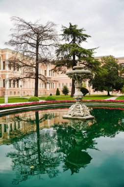 İstanbul, Türkiye 'deki Dolmabahçe Sarayı' nın bahçesinde süslü bir mermer çeşme ve havuz