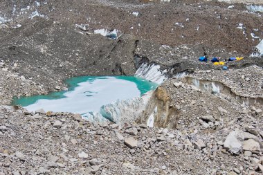 Melt pools inside the Khumbu Glacier near expedition tents in the Everest base camp, Nepal clipart