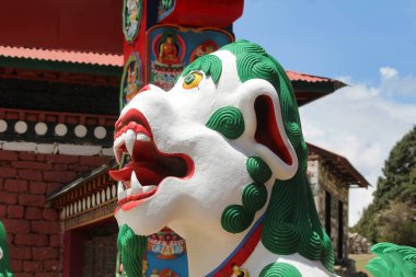 Mythical Tibetan Lion statue at the Tengboche Monastery in Nepal clipart