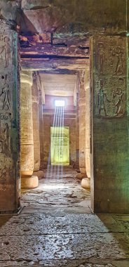 Atmospheric image of the evening sun streaming through rock cut windows in the Hypostyle gallery of the magnificent Temple of Seti built in 13th century BC by the Pharoah Seti I near Abydos,Egypt clipart