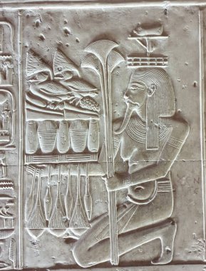 Mısır 'ın Abydos yakınlarındaki Pharoah Seti I tarafından MÖ 13. yüzyılda inşa edilen Seti Tapınağı' nda kazlar, meyveler ve ekmeklerle dolu bir adak masasını tutarken gösterilen Nil Tanrısı Hapi 'nin duvar levhaları.