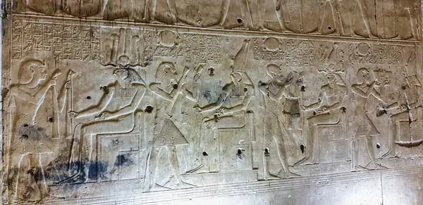 stock image Pharoah Seti I makes offerings to different forms of God Horus in the Chapel of Horus in this painted wall relief in the Temple of Seti built in 13th century BC by the Pharoah Seti I near Abydos,Egypt