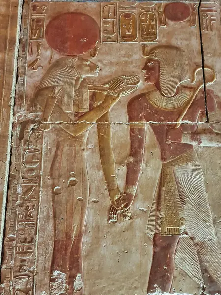 stock image Pharoah Seti I offering prayers to lion goddess Sekhmet in a painted wall relief in the Temple of Seti built in 13th century BC by the Pharoah Seti I near Abydos,Egypt