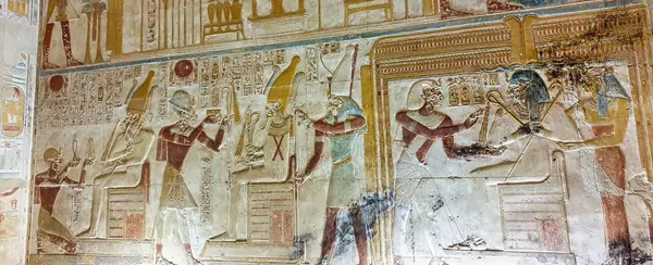 stock image Pharoah Seti I offering prayers to guardian diety of the underworld, Osiris in this painted wall reliefs in the Temple of Seti built in 13th century BC by the Pharoah Seti I near Abydos,Egypt