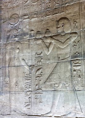 Detailed Wall reliefs depicting Pharoah Ptolemy VI making offering to Isis weaing crown of Egypt the Temple of Isis at Philae Island built by the Ptolemy Pharoahs near Aswan,Egypt clipart