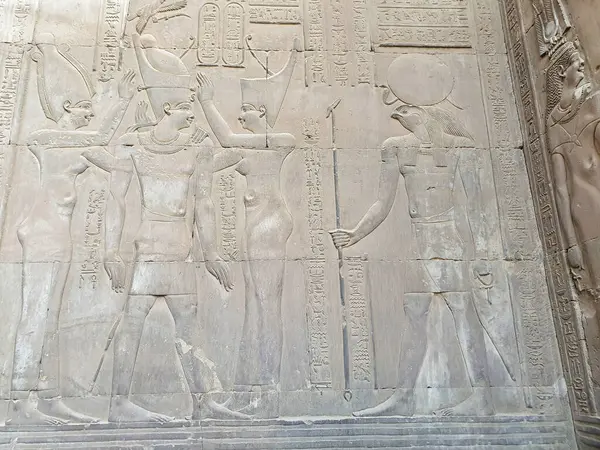 stock image Wall Relief of Wadjet and Nekhbet goddesses of lower and upper egypt crowning Ptolemy VIII Euergetes II in front of Haroeris at the Temple of Sobek and Haroeris in Kom Ombo,Near Aswan,Egypt