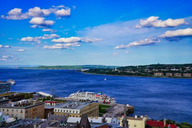 Magnificent Wide angle panorama view on a brillant summer day from the top of the Dufferin terrace of the St. Lawrence river with the town of Levi on the eastern shore in Quebec city, Canada clipart