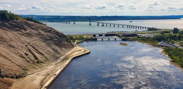 Montmorency Şelalesi 'nin tepesinden Saint Lawrence nehrinin panoramik manzarası. Kanada' nın Quebec eyaletinin başkenti Quebec yakınlarında, güneşli bir yaz gününde Pont de Ille köprüsü manzarası.