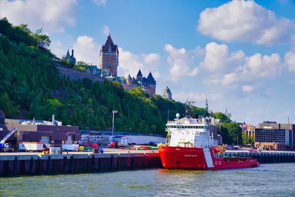 stock image Canadian Coast Guard ship,Vincent Massey  with a view of the Chateau Fairmont Frontenac Hotel in the background in this view from the cruise boat on the St.Lawrence river in Quebec city, Canada