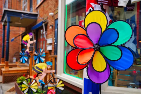 stock image A Colorful show piece of a flower with multi colored petals made of synthetic material outside a shop in Quebec's petit champlain shopping district in Quebec city,Canada