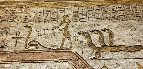 stock image Wall relief of a snake with three heads and human feet depicts creatures in the netherworld visible in the 5th hour of the Amduat in the Tomb of Ramesses III,KV11, in the Valley of Kings,Luxor,Egypt