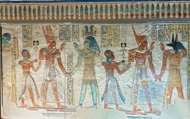 Ramses III and Amenherkhepshef led foward by Tatenen and dog-headed Duamutef in a wall relief in the Tomb of Amenherkhepshef,Prince and Son of Pharoah Ramesses III,QV55, Valley of Queens,Luxor,Egypt clipart