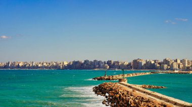 View of Alexandria's skyline with sea facing buildings along the corniche of the deep blue Mediterranean sea viewed from the Citadel of Qaitbay,built by the Mamluk Sultan Qaitbay,Alexandria,Egypt clipart