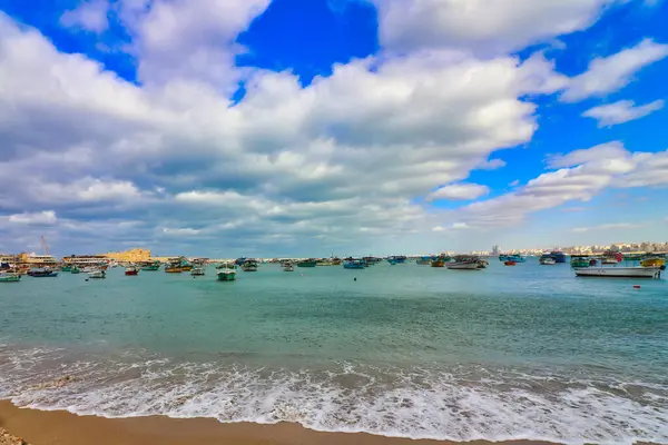 stock image Fishing boats dot the eastern harbour of Alexandria with the Citadel of Qaitbay in the distance on a bright sunny day at Alexandria,Egypt