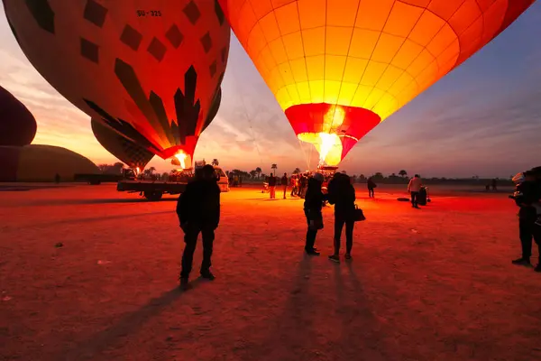 stock image Luxor,Egypt,January 2,2020-Blasts of flames from propane burners fill safari balloons with hot air for joyrides over the world famous ancient egyptian sites over Luxor,Egypt