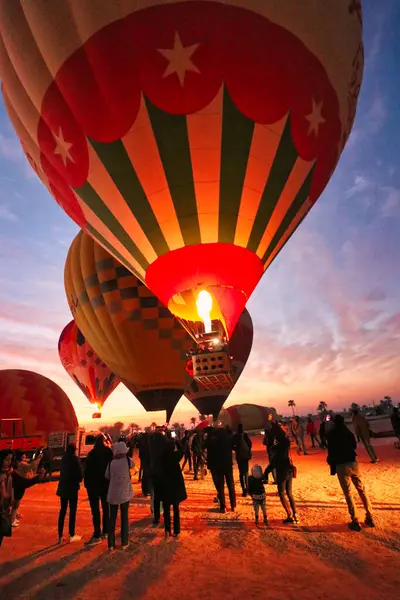 stock image Luxor,Egypt,January 2,2020-Dramatic shot of blast of hot air from the propane burners as a Hot Air Balloon rises with tourists into the pre-dawn skies over Luxor,Egypt