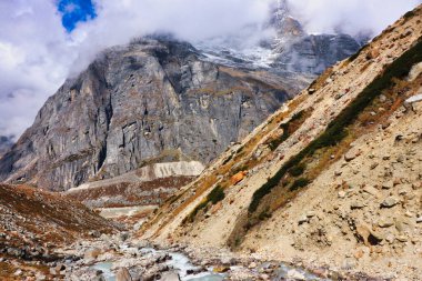 Rugged trail rises over rocky glacial terrain following the Hinku river up to Khare village on route to the  Base camp of Mera Peak,a 6476 meter high peak in the Khumbu Himalayas,Nepal clipart