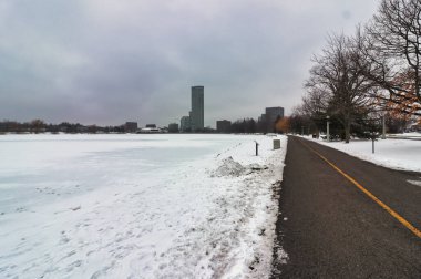 A quiet walking trail cleared of snow along side the frozen Dows Lake in central area of Ottawa,Ontario,Canada clipart